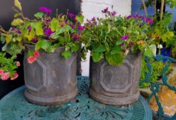 A pair of cylindrical faux lead planters