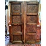 A pair of Middle Eastern carved door possibly Berber, each door being made from a single piece and