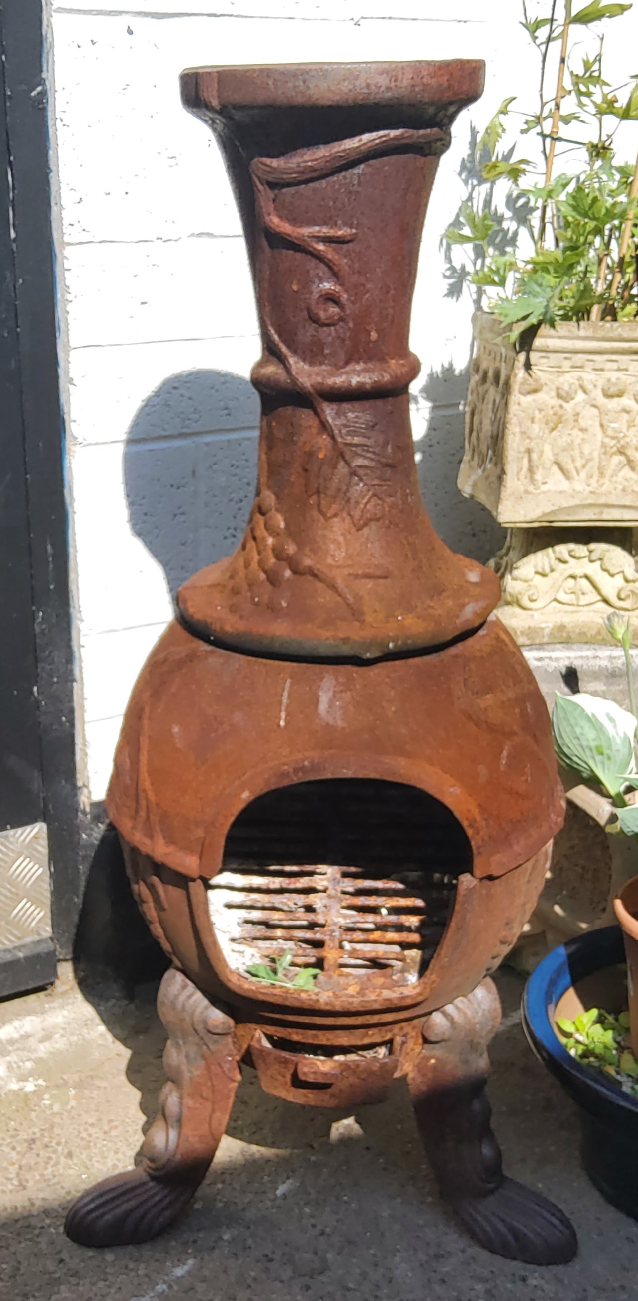 A large cast metal garden chiminea