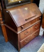 An 18th century oak bureau, the fall front enclosing well and pigeon holes, above two drawers,