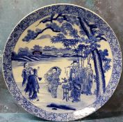 A 19th century Chinese blue and white charger, decorated with elders, pine tree and pagodas,