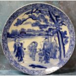 A 19th century Chinese blue and white charger, decorated with elders, pine tree and pagodas,