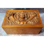 A 19th century walnut rectangular box, the cover in relief with mask and cornucopias, 20cm wide, c.