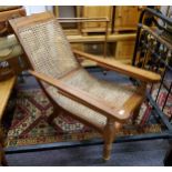 A late 19th/ early 20th century plantation chair, rattan seat, fold out leg rests c.1900