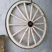 A pair of cart wheels, painted white