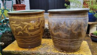 Two large Chinese planters decorated with a ferocious dragon chasing the pearl with Scripture