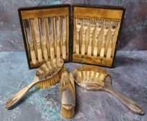 A Walker & Hall three piece silver dressing table set, Chester 1929; a set of six EPNS and mother of