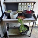 A wooden garden / potting shed station