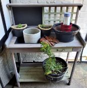A wooden garden / potting shed station