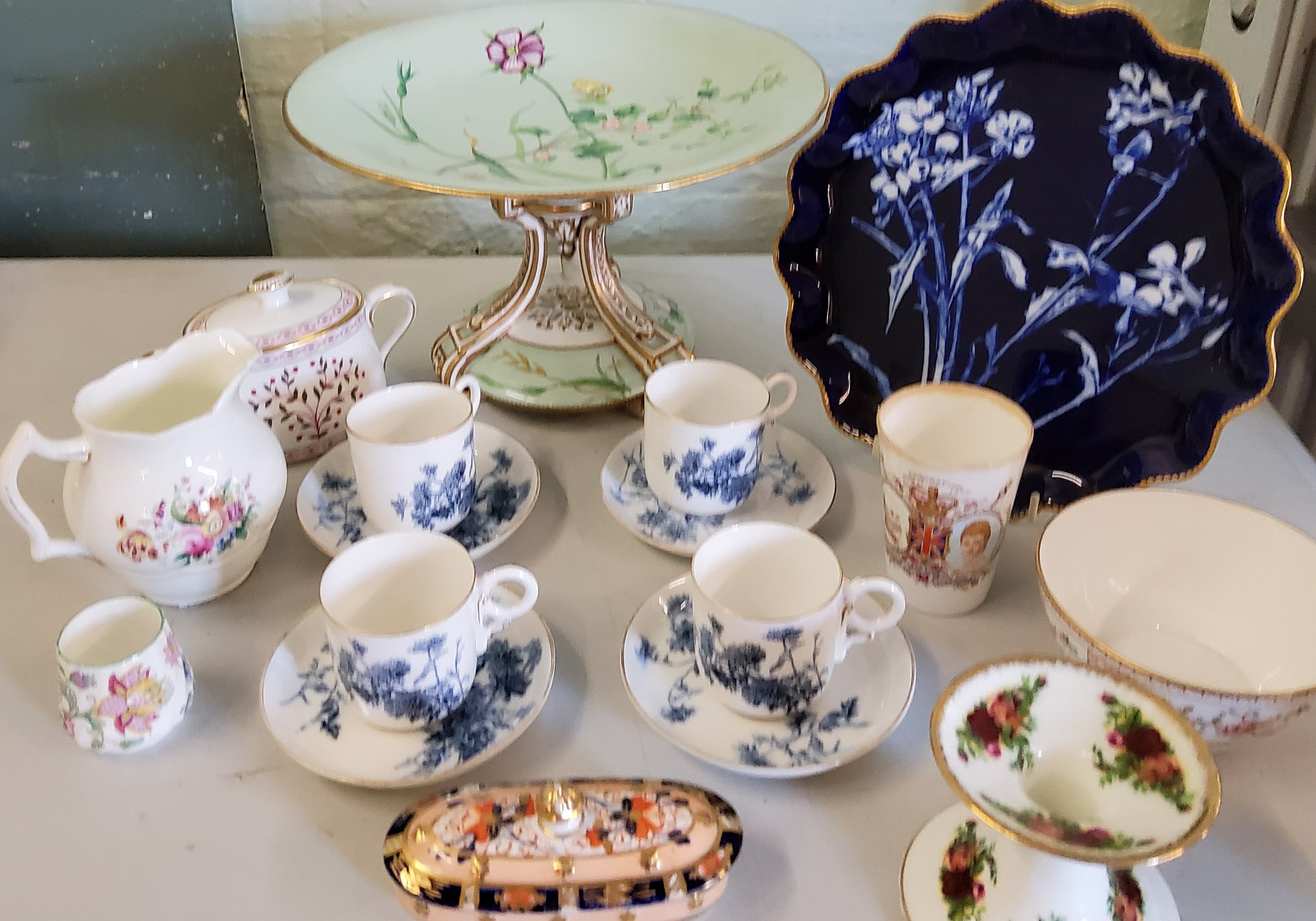 A Minton comport, painted in pattern G305 with wild plant and flower specimens on a pale green