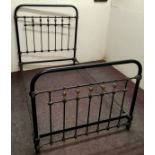 A Victorian cast iron double bed frame, picked out in gilt, with supports