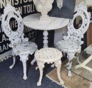 A pair of Coalbrookdale style medallion back garden chairs, painted white with conforming