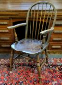 A 19th century ash and elm Windsor chair, arched spindle back rest, well figured elm seat, turned