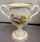 A Victorian Coalport type  two handled loving cup, painted with landscape cartouches within a gilt