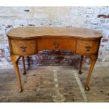 A small kidney shaped dressing table with one long flanked by two short drawers height 74.5cm x