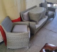 A modern woven wicker effect conservatory suite comprising of a two seater sofa, two armchairs and a