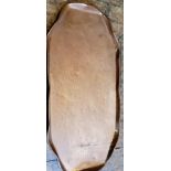 An Arts and Crafts Newlyn type copper shaped oval tray, engraved with stylised fish and fronds, 57cm