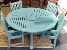 An English teak garden patio table and four armchairs, made by Lister, painted sage green, central