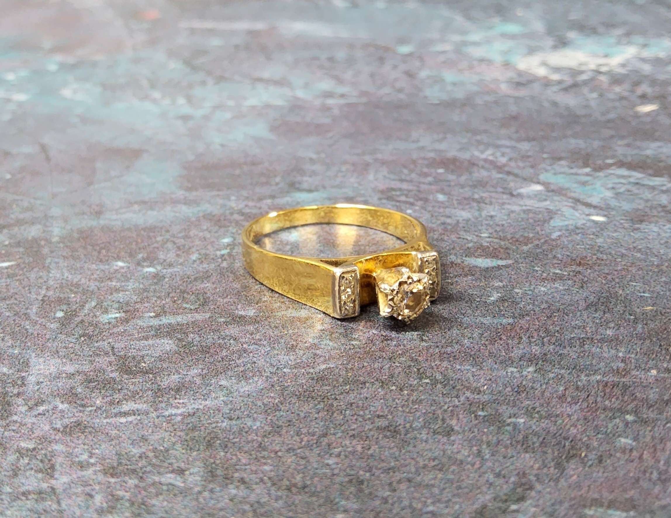 An 18ct gold solitaire ring claw set with an approx. 12.5pt round diamond, the shoulders set with