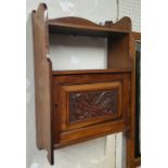 A Victorian walnut wall cabinet, with shaped gallery above open shelf, carved fielded panelled door,