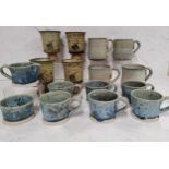 A set of six Studio Pottery mugs, cream jug and sugar bowl, glazed in crystallised blue, 5.5cm high,