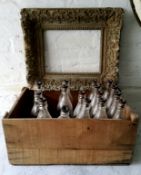 A 19th century frame, heavily distressed; a crate of early 20th century bottles