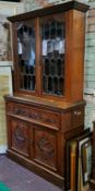 A late Victorian mahogany secretaire cabinet, with moulded cornice above two glazed doors, enclosing