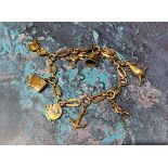 A 9ct gold fancy link bracelet with eight charms including a telephone dial, a Hohner Accordion,
