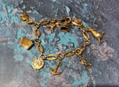 A 9ct gold fancy link bracelet with eight charms including a telephone dial, a Hohner Accordion,