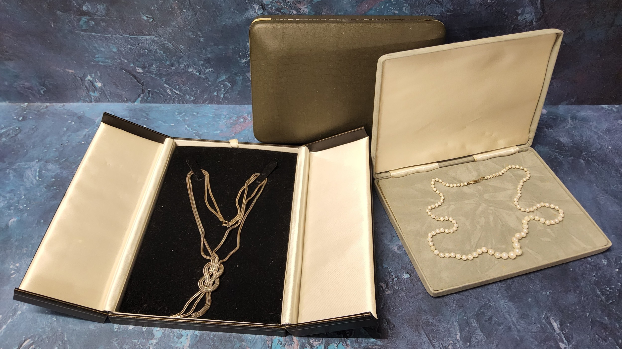 A graduated pearl necklace, 9ct gold clasp, original box; a contemporary multi link knot necklace in