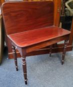 A 19th century mahogany folding tea table, rounded rectangular top, secret compartment, turned legs,