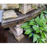 A reconstituted stone garden bench