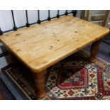 A farmhouse pine coffee table, boldly turned legs
