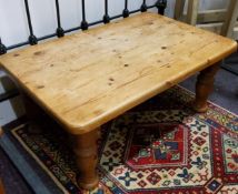 A farmhouse pine coffee table, boldly turned legs