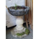 A reconstituted stone pedestal acanthus capped planter / urn