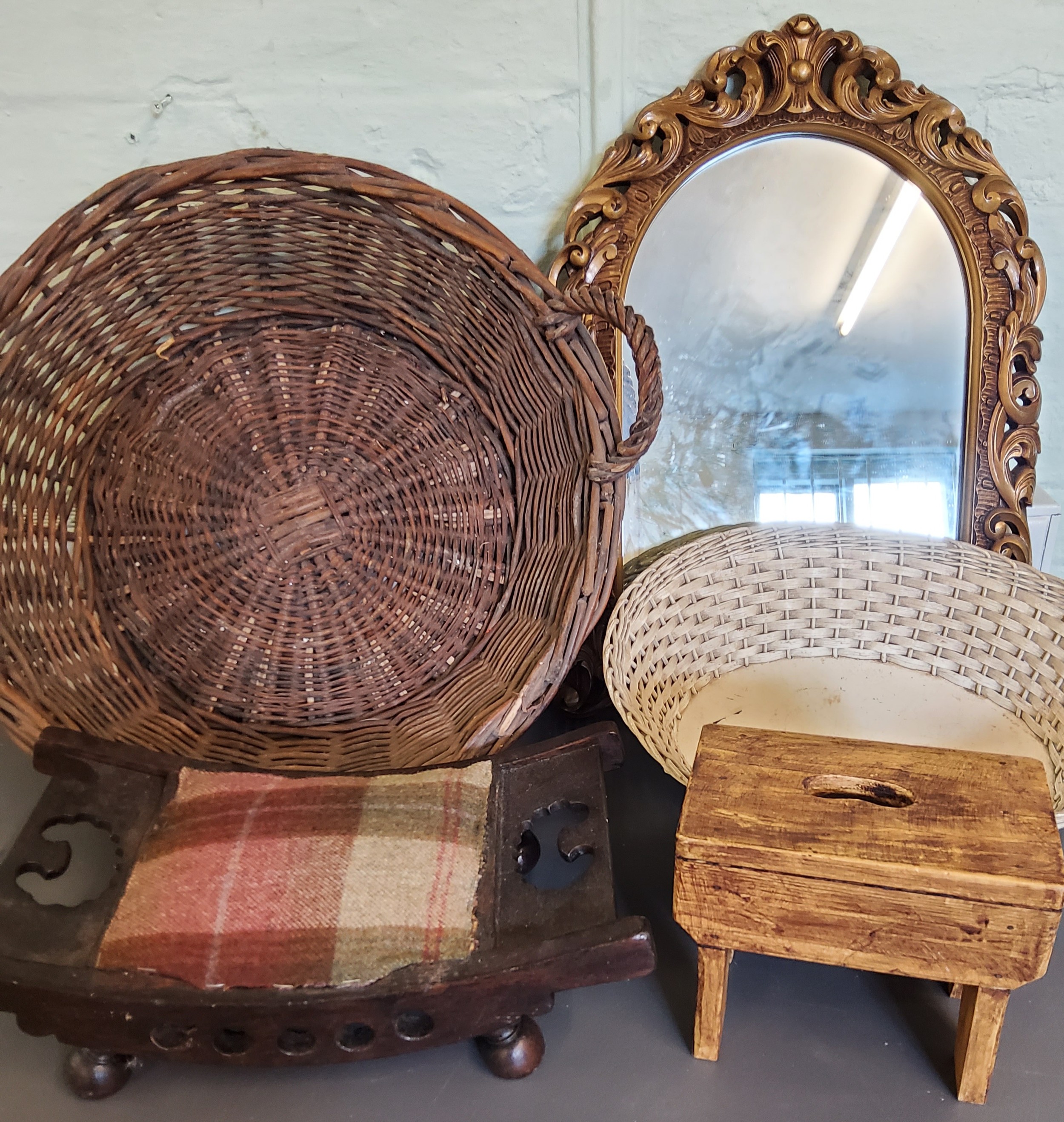 A two handled wicker basket;  a foot stool;  another;  an arched gilt foliate pierced mirror;  etc