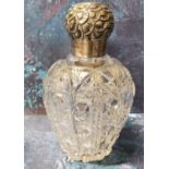 A large Victorian clear cut glass and silver scent bottle, the screw-off cover embossed with