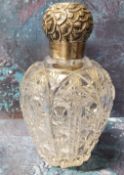 A large Victorian clear cut glass and silver scent bottle, the screw-off cover embossed with