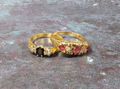A 9ct gold five stone ring set with a central round ruby, flanked by two round diamonds and