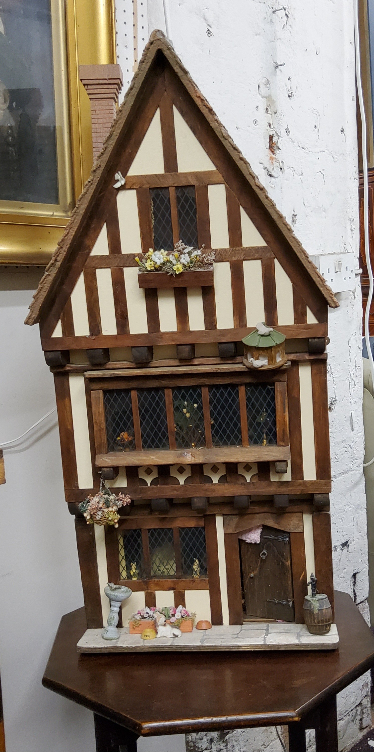A large 20th century doll's house, Tudor House, three story, with furniture, accessories and