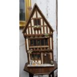 A large 20th century doll's house, Tudor House, three story, with furniture, accessories and