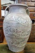 A substantial 20th century amphora style terracotta vase, wavey geometric panels throughout,  49cm