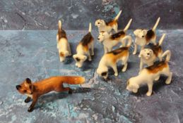 Eight Beswick fox hounds, various poses;  a Beswick fox (9)