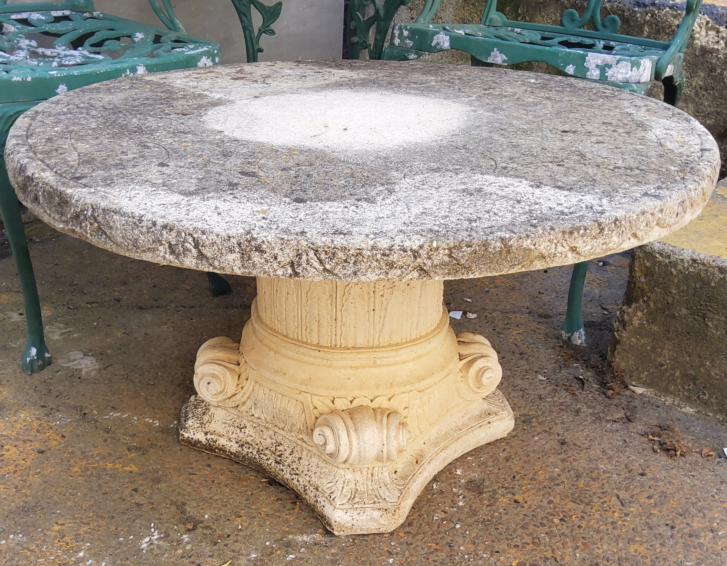 A reconstituted stone classical column garden table