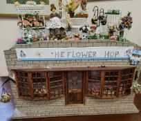 A 20th century doll's house shop, The Flower Shop, with accessories including flower carts,