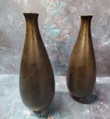 A pair of Japanese bronze ovoid vases, engraved with leaves, 23.5cm high, Meiji period