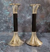 A pair of Art Deco style candlesticks, ribbed flared nozzle, ebonised column, conforming flared