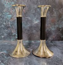 A pair of Art Deco style candlesticks, ribbed flared nozzle, ebonised column, conforming flared