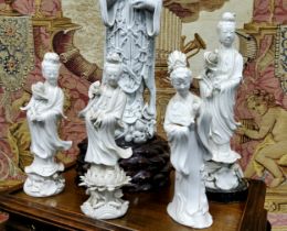Four 19th century Blanc de Chine figure, Guanyin, standing holding a lotus, 22cm high;  another,