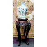 A 19th century Chinese hardwood jardiniere / temple vase stand, carved with oriental iris flower